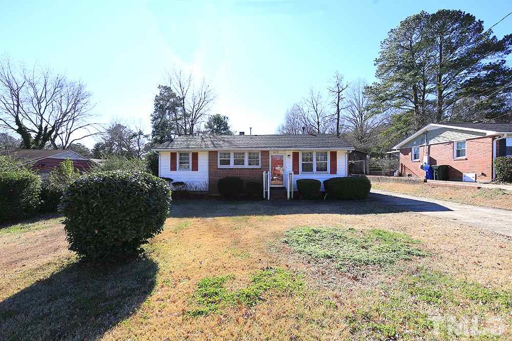 848 Newcombe Road Raleigh, NC 27610 - Photo 2 of 14 a front view of a house with a yard covered with snow and trees