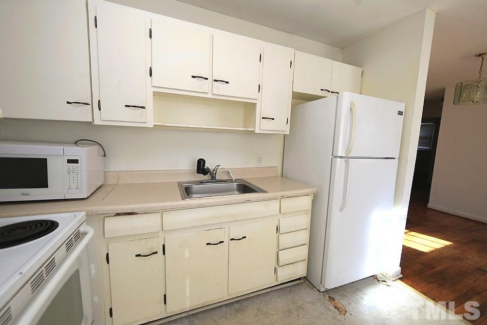848 Newcombe Road Raleigh, NC 27610 - Photo 6 of 14 a kitchen with cabinets appliances a sink and a counter space