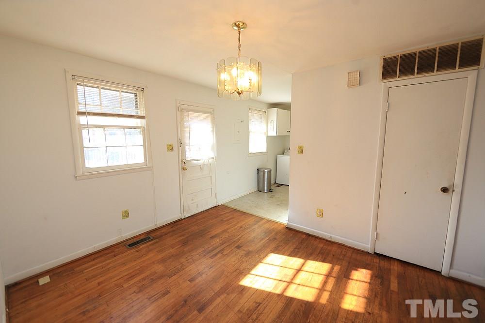 848 Newcombe Road Raleigh, NC 27610 - Photo 8 of 14 a view of an empty room with wooden floor and a window