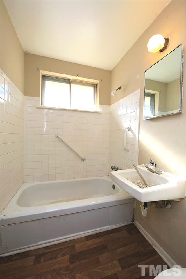 848 Newcombe Road Raleigh, NC 27610 - Photo 10 of 14 a bathroom with a bathtub and a sink