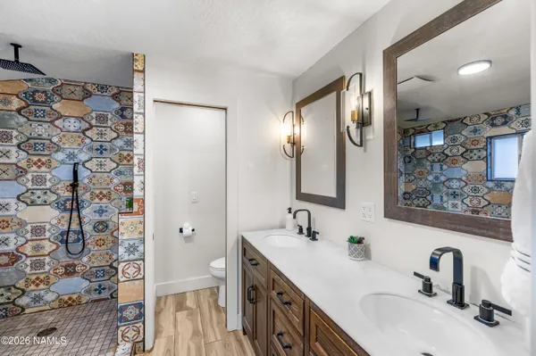 a kitchen with stainless steel appliances granite countertop a sink a stove a refrigerator and chairs