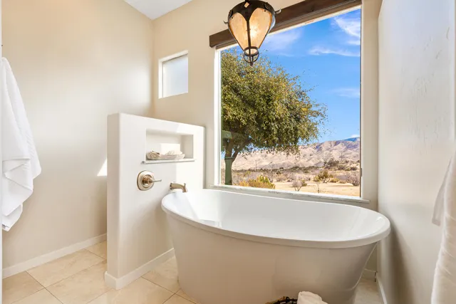 a bathroom with a granite countertop toilet sink and mirror