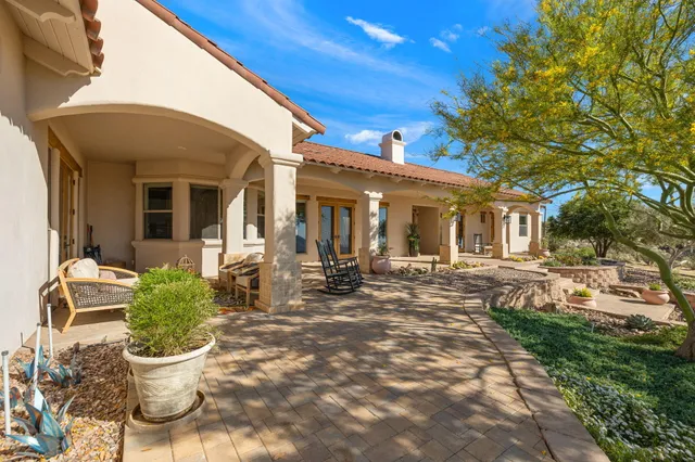a view of a house with backyard sitting area and garden