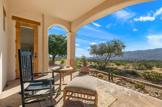 a very nice looking room with a large window and furniture