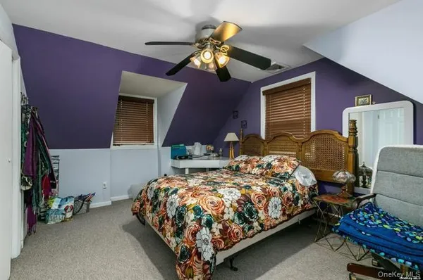 a bedroom with bed and a chandelier