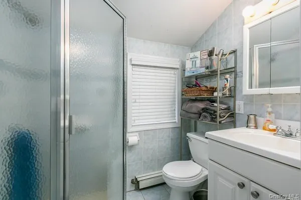 a bathroom with a sink a toilet and shower curtain