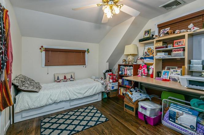 250 North Rutherford Avenue Massapequa, NY 11758 - Photo 15 of 21 a bedroom with bed and a mirror on dresser