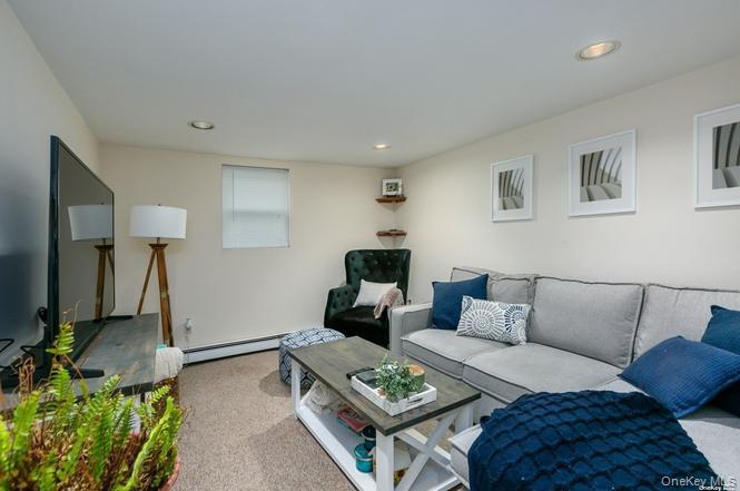 250 North Rutherford Avenue Massapequa, NY 11758 - Photo 17 of 21 a living room with furniture and a couch