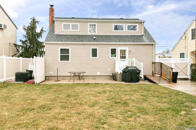 250 North Rutherford Avenue Massapequa, NY 11758 - Photo 21 of 21 a view of a house with a big yard and a large window