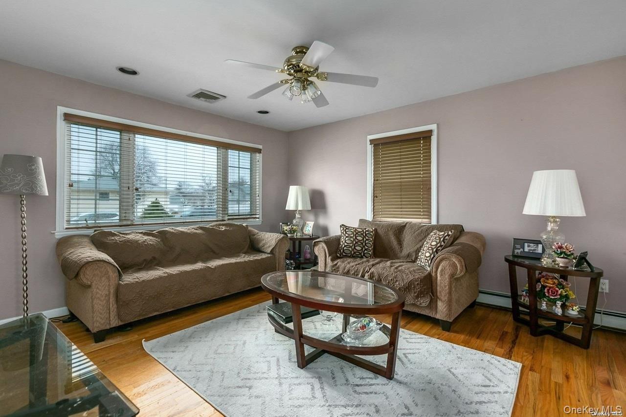250 North Rutherford Avenue Massapequa, NY 11758 - Photo 4 of 21 a living room with furniture and a large window
