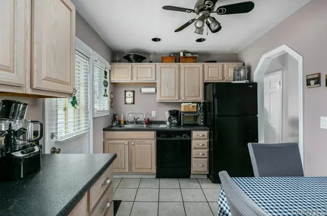 a kitchen with stainless steel appliances granite countertop a refrigerator a stove a sink dishwasher and a refrigerator