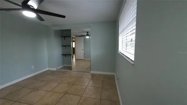 en empty room with windows and entrance