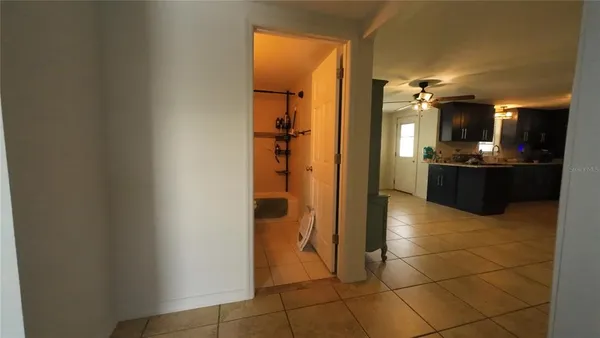 a view of a hallway with living room and a bathroom
