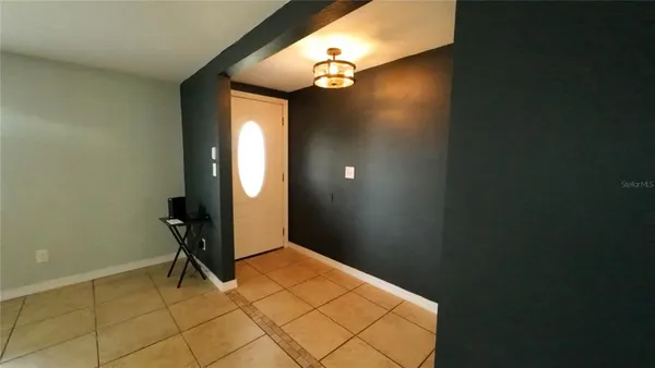 a view of a room with a mirror and cabinets