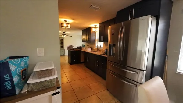 a kitchen with stainless steel appliances granite countertop a refrigerator and a stove