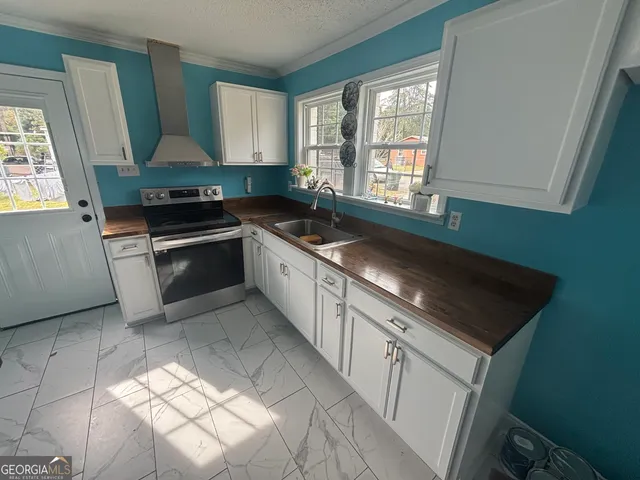 a kitchen with granite countertop a sink and a stove