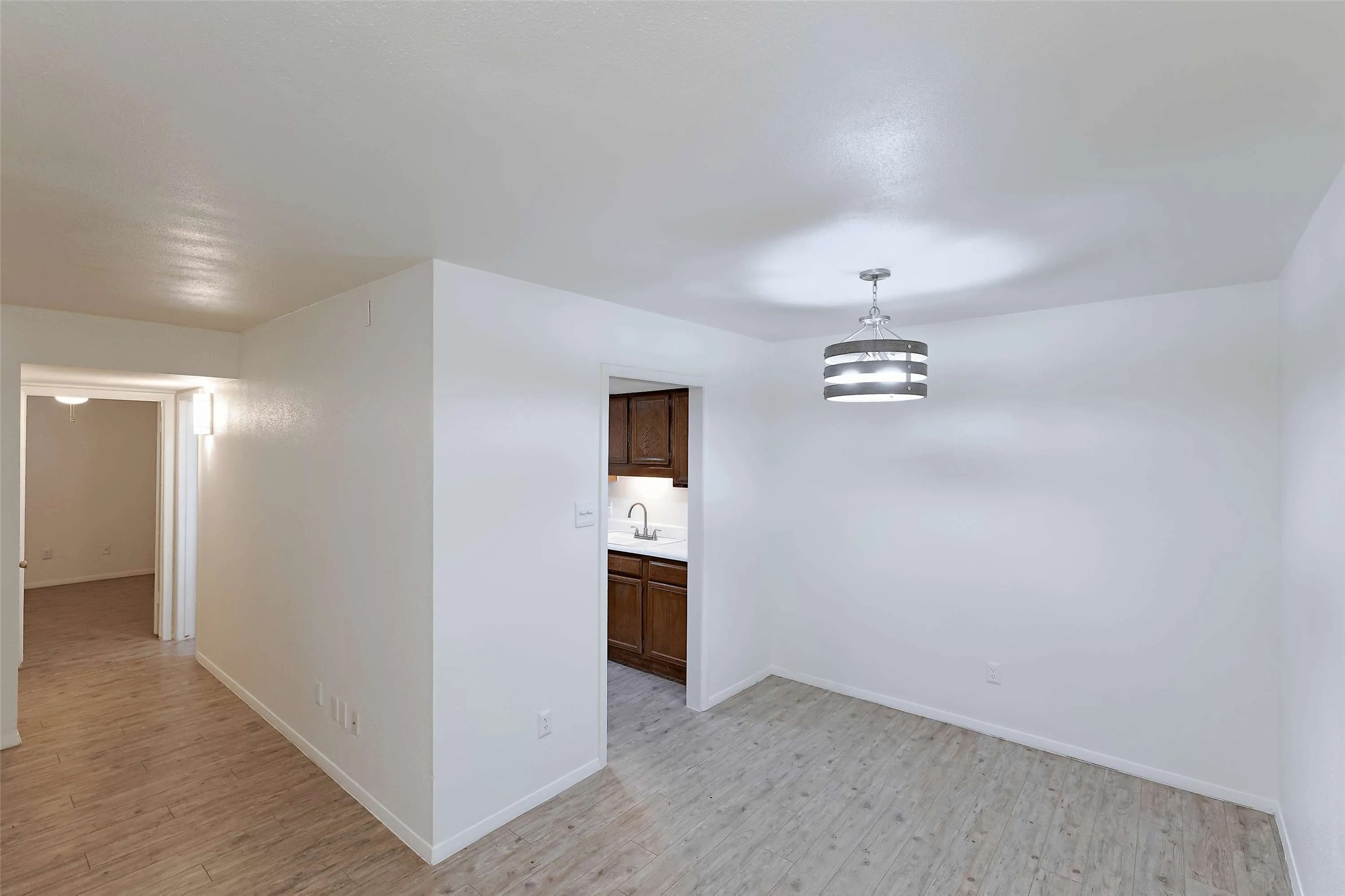 8405 Bent Tree Road, Unit 3412 Austin, TX 78759 - Photo 5 of 20 an empty room with an entryway and wooden floor