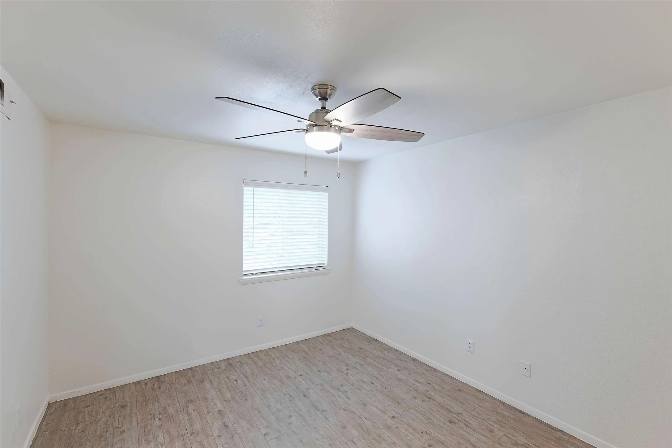 8405 Bent Tree Road, Unit 3412 Austin, TX 78759 - Photo 8 of 20 an empty room with a window and a fan