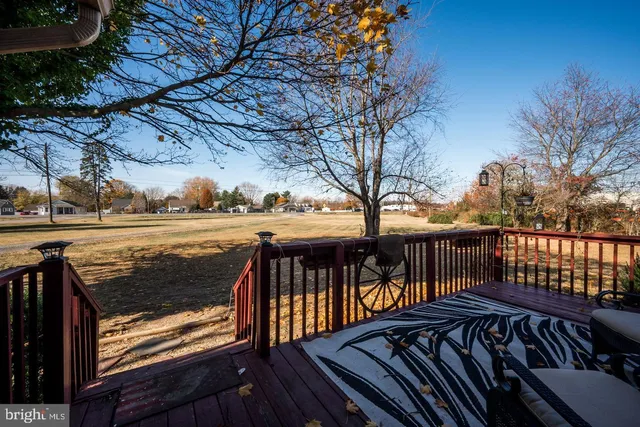a view of a roof deck with wooden fence and floor