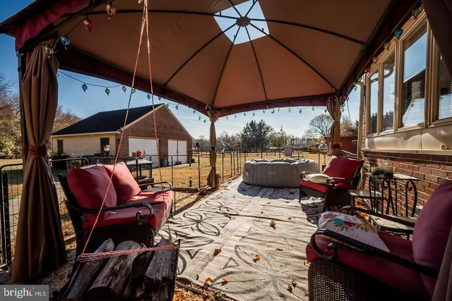 a view of a patio with table and chairs under an umbrella