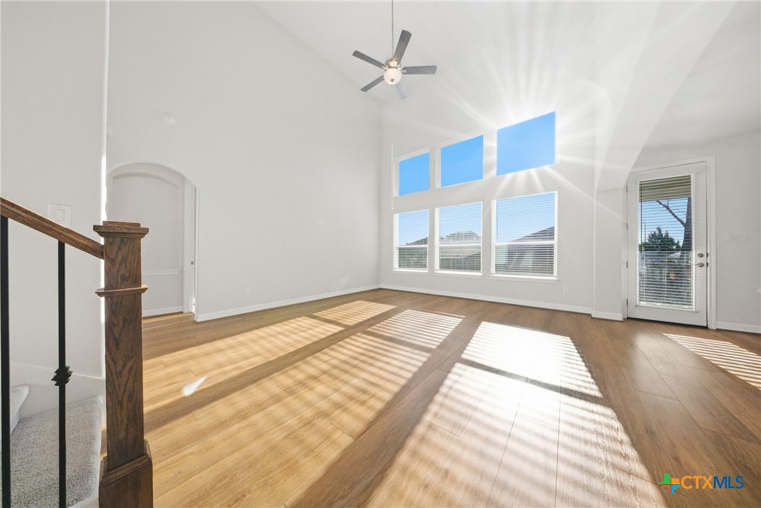 662 Hidden View Street New Braunfels, TX 78130 - Photo 11 of 46 a view of an empty room with a window and wooden floor