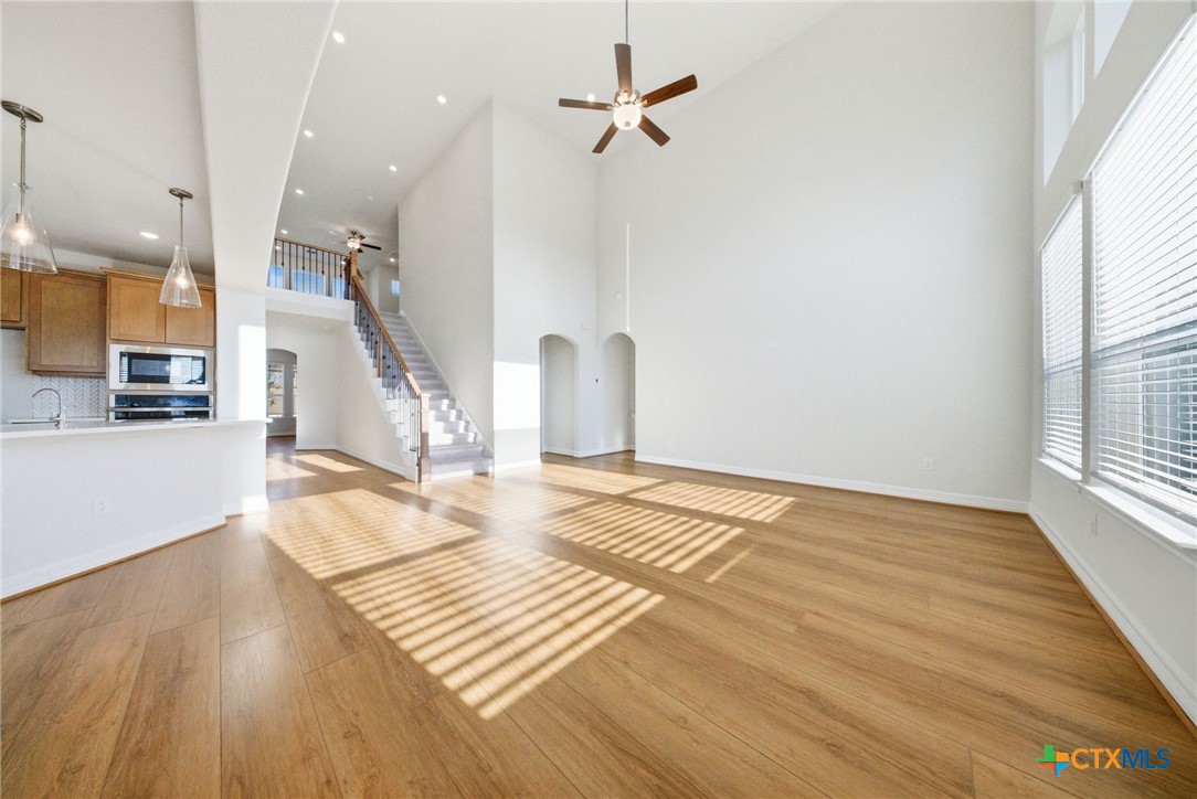 662 Hidden View Street New Braunfels, TX 78130 - Photo 13 of 46 a view of a livingroom with wooden floor and a ceiling fan