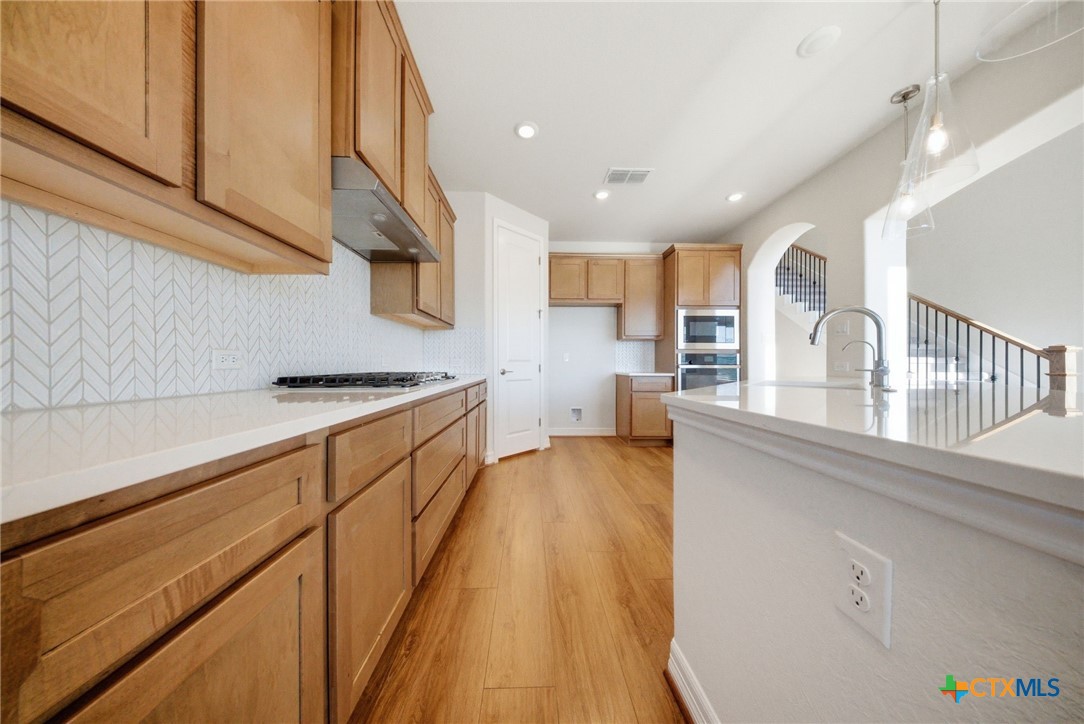 662 Hidden View Street New Braunfels, TX 78130 - Photo 17 of 46 a kitchen with cabinets a sink and appliances