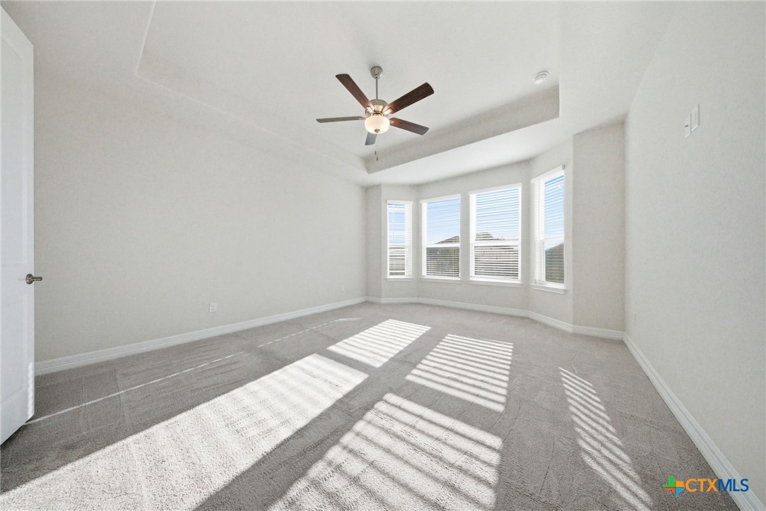 662 Hidden View Street New Braunfels, TX 78130 - Photo 22 of 46 a view of a bedroom with wooden floor and windows