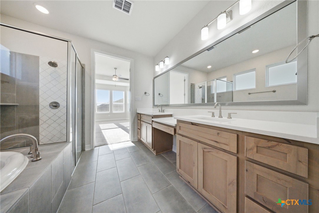 662 Hidden View Street New Braunfels, TX 78130 - Photo 24 of 46 a large white kitchen with a sink and cabinets