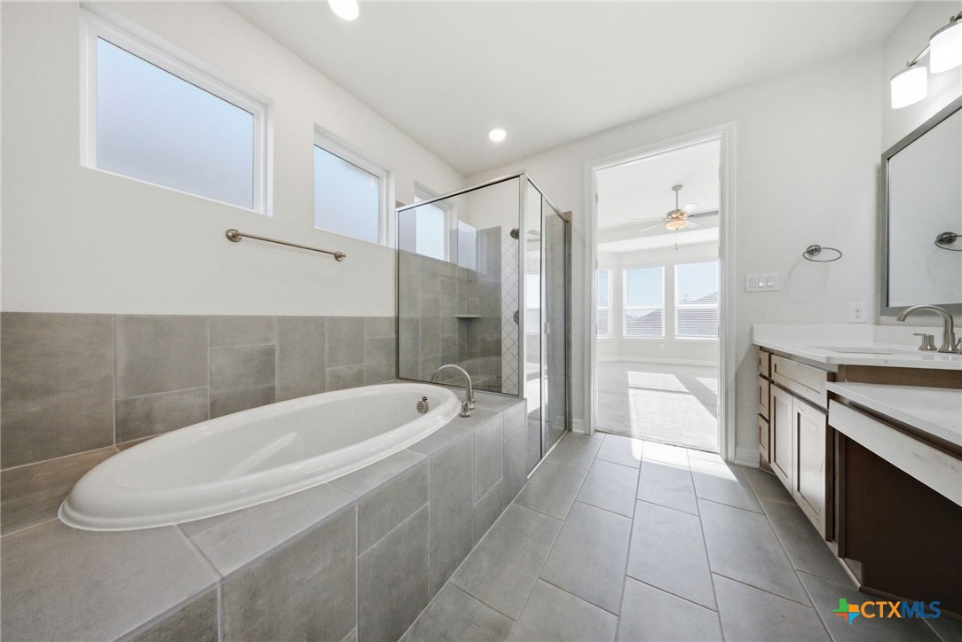 662 Hidden View Street New Braunfels, TX 78130 - Photo 25 of 46 a spacious bathroom with a tub sink and mirror