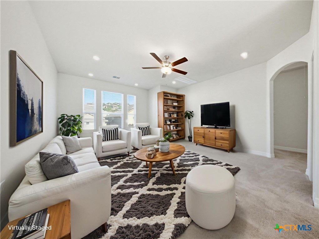 662 Hidden View Street New Braunfels, TX 78130 - Photo 29 of 46 a living room with furniture and a flat screen tv