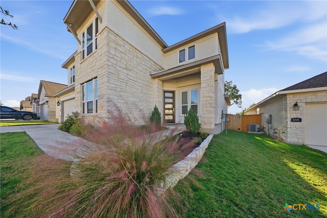 662 Hidden View Street New Braunfels, TX 78130 - Photo 3 of 46 a front view of a house with garden