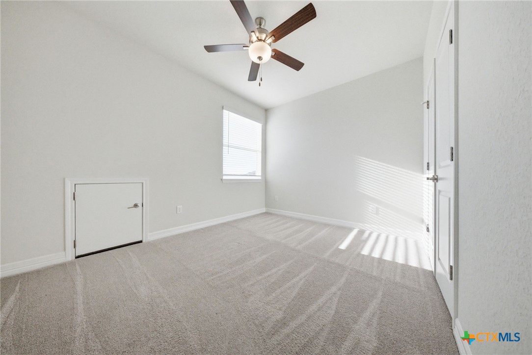 662 Hidden View Street New Braunfels, TX 78130 - Photo 33 of 46 an empty room with fan and windows