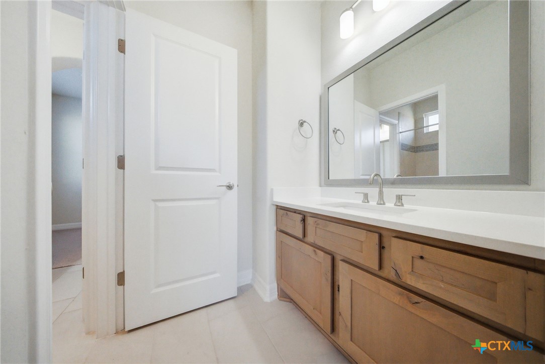 662 Hidden View Street New Braunfels, TX 78130 - Photo 38 of 46 a bathroom with a double vanity sink and mirror