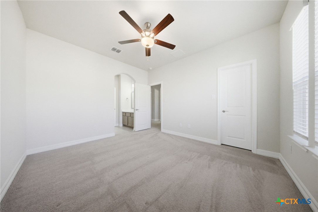 662 Hidden View Street New Braunfels, TX 78130 - Photo 40 of 46 an empty room with windows and fan