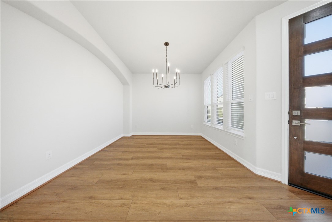 662 Hidden View Street New Braunfels, TX 78130 - Photo 6 of 46 a view of empty room with wooden floor and fan