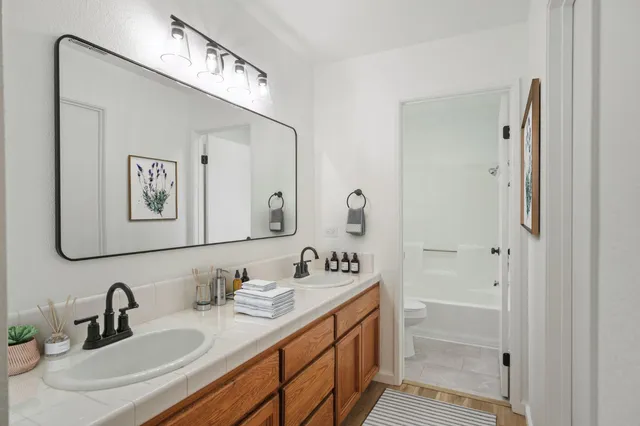 a bathroom with a double vanity sink and a mirror