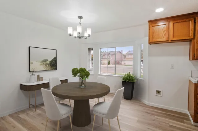 a view of a dining room with furniture and chandelier