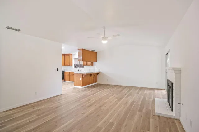 a view of a kitchen with wooden floor and a sink
