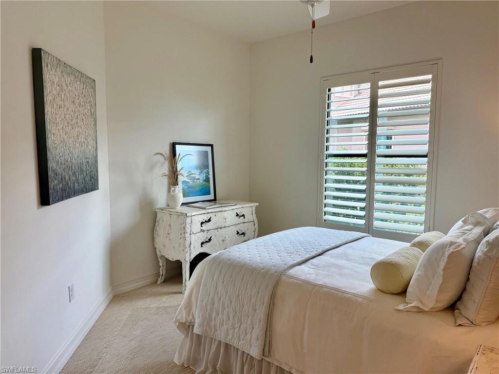 7476 Moorgate Point Way Naples, FL 34113 - Photo 12 of 20 a bedroom with a bed and wooden floor