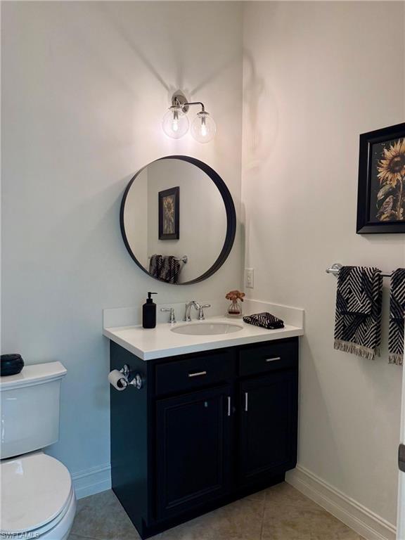 7476 Moorgate Point Way Naples, FL 34113 - Photo 14 of 20 a bathroom with a toilet sink vanity and mirror