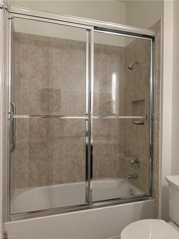 7476 Moorgate Point Way Naples, FL 34113 - Photo 15 of 20 a bathroom with a glass shower door