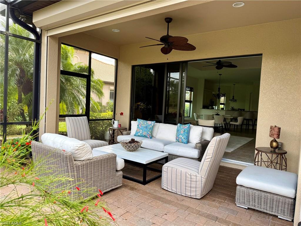 7476 Moorgate Point Way Naples, FL 34113 - Photo 18 of 20 a living room with furniture and a large window