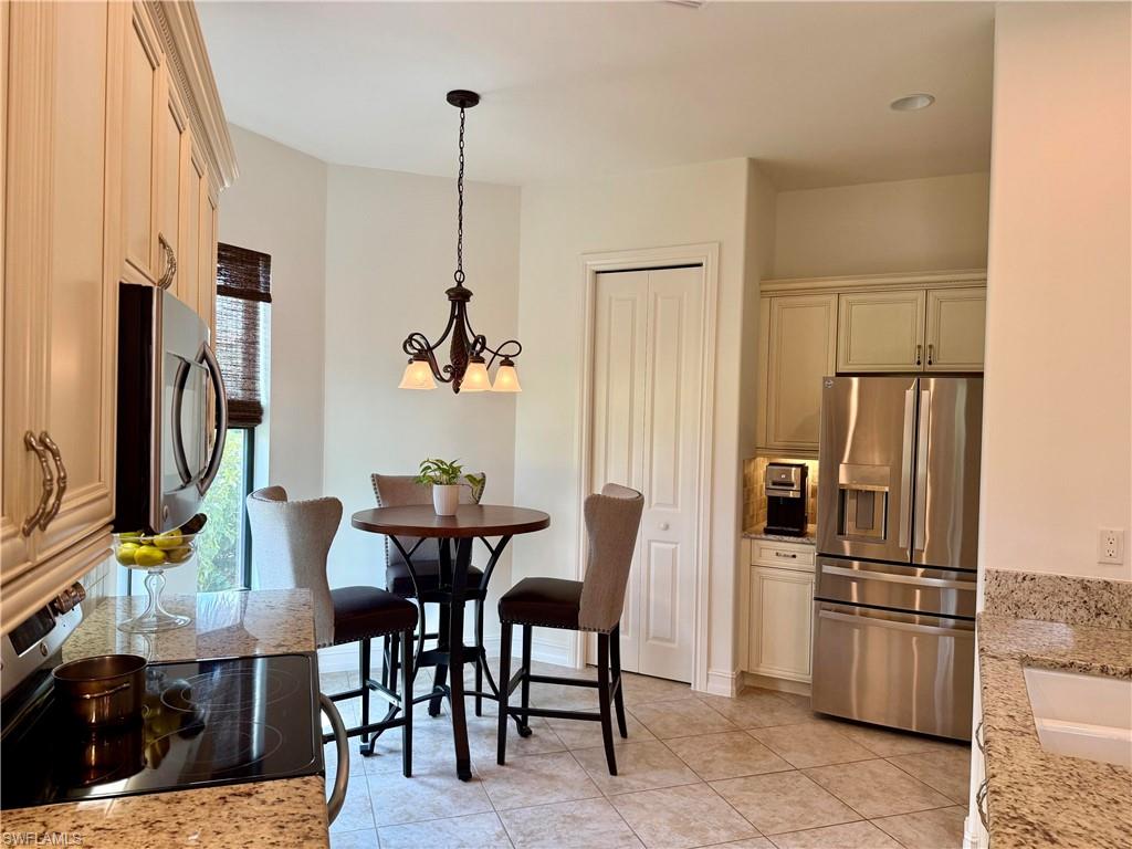 7476 Moorgate Point Way Naples, FL 34113 - Photo 7 of 20 a view of a dining room with furniture window and stainless steel appliances