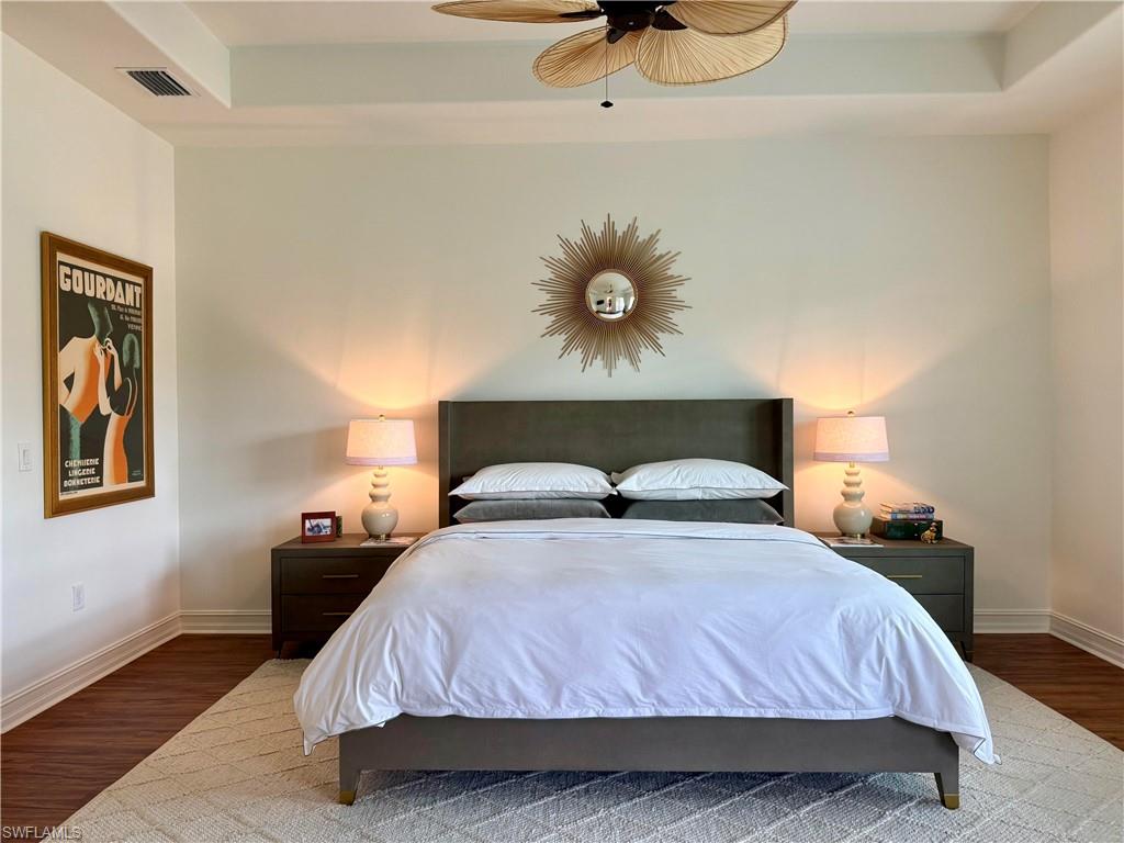 7476 Moorgate Point Way Naples, FL 34113 - Photo 8 of 20 a bedroom with a bed and painting on the wall