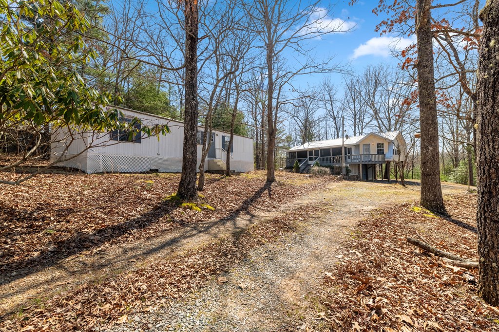 1262 Maple Grove Road Morganton, GA 30560 - Photo 46 of 68 a yellow house with trees in front of it