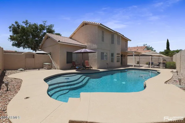 a view of a swimming pool with a yard