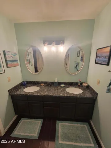 a bedroom with a bed a window and wooden floor