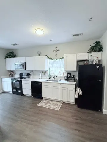 a white toilet sitting next to a white wall