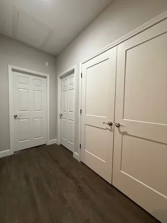 a bathroom with a granite countertop sink a toilet and a mirror